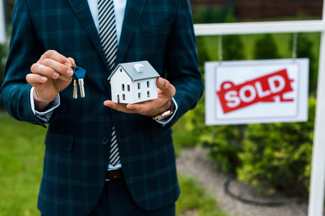 View Realtor Holding Carton